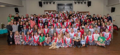 Local foster youth and their allies gather for FYI's annual holiday party. Each of the 76 youth received a stocking and gifts from the community at the event, in addition to participating in a fun team gingerbread house decorating contest. Courtesy photo.