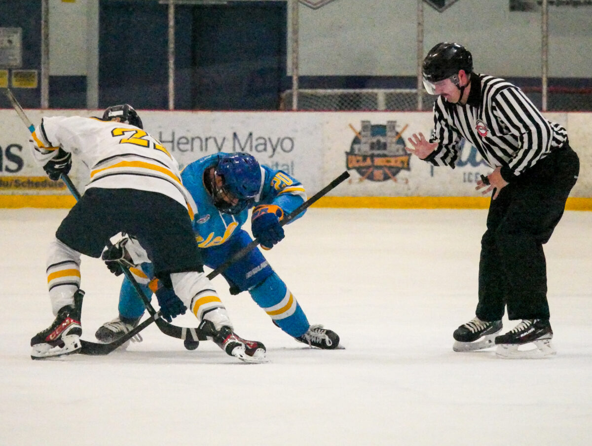 Steven Soos (20) from UCLA and Sam Kliensmith (22) from NAU fight for the puck during the West Coast Hockey Conference Championship at the Cube Ice and Entertainment Center on Sunday, Feb. 12. Katherine Quezada/The Signal