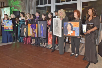 Honorees and artists join on the dance floor with their artwork during the Empowering HeArts Gala held at the Sand Canyon Country Club in Santa Clarita on Friday, 022324. Dan Watson/The Signal