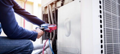 Technician is checking air conditioner ,measuring equipment for filling air conditioners.