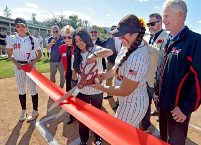 Hart High School softball teammates Francesca Vega, center, and Kaylee Rodriguez cut the ribbon during the Hart softball field ribbon cutting ceremony at Hart High School on Tuesday, 031224. Dan Watson/The Signal