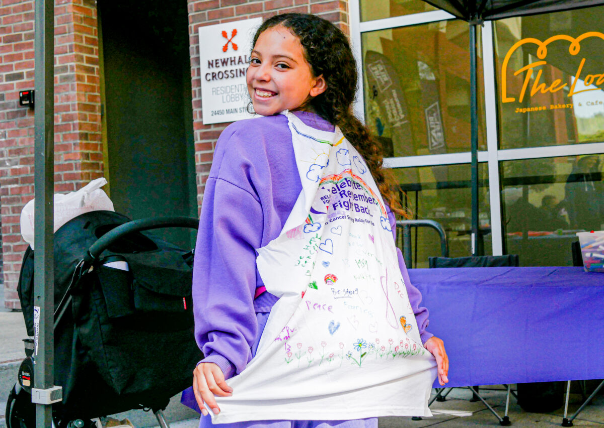Maurielle Chapman (10) decorates a superhero cape with words such as “Fearless” and “Peace” that aims to represent the fight against cancer during the “Relay for Life” Tune-Up on Saturday morning in Old Town Newhall. Katherine Quezada/The Signal