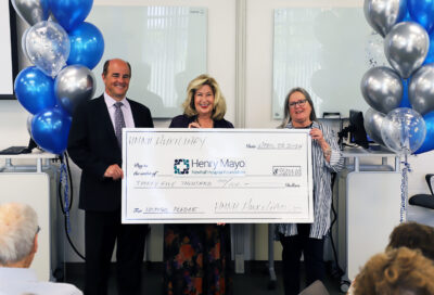 Henry Mayo Newhall Hospital Auxiliary President Debbie Burkhart presents the last $35,000 donation, fulfilling the group’s 9-year-old $600,000 pledge, to HMNH Foundation President Marlee Lauffer and HNMH President/ CEO Kevin A. Klockenga. Courtesy photo.
