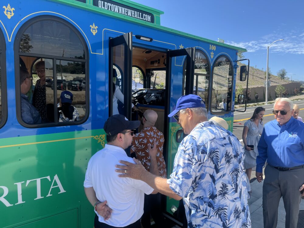 City Councilman Bill Miranda speaks to the driver of the city's trolley before boarding Monday. Perry Smith/The Signal