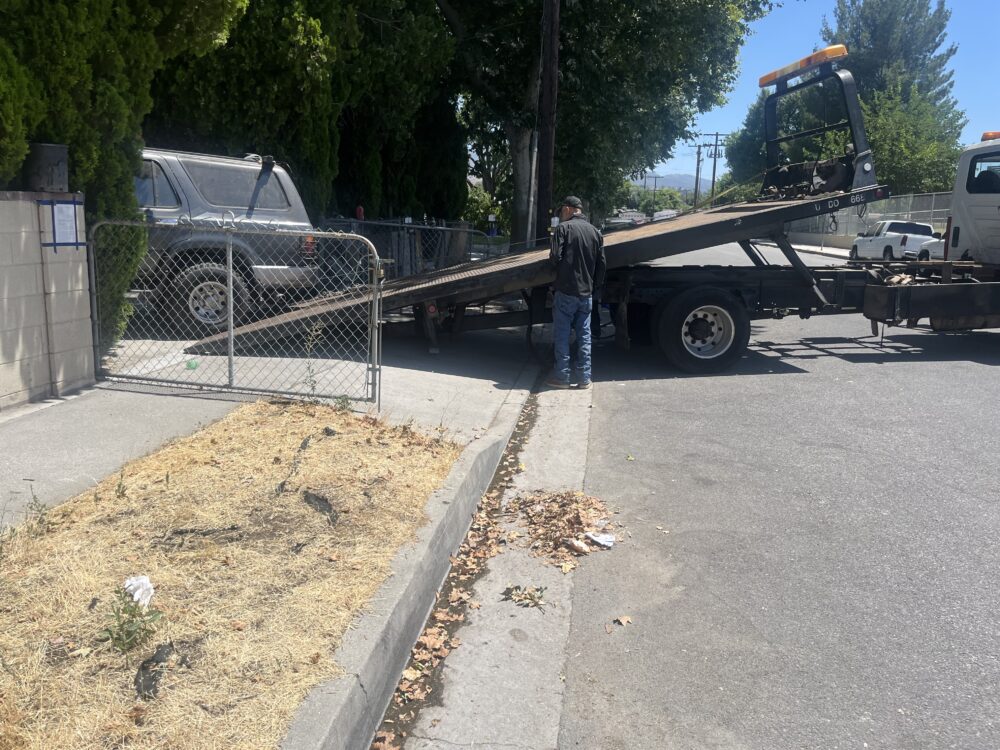 The property was covered in trash Wednesday afternoon as a dust-covered black Toyota 4Runner was being towed from the front yard, and about a half-dozen notices could be seen posted to the front door with blue painters’ tape.
