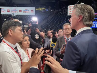 California Gov. Gavin Newsom speaks to reporters at Georgia Tech’s McCamish Pavilion near the site of the debate between President Joe Biden and former President Donald Trump in Atlanta on June 27, 2024. Photo courtesy of The Epoch Times.