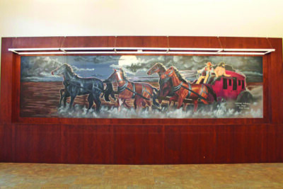 This 1976 mural, Adventures in Fantasy, depicts a stagecoach pulled by a team of six horses and riding through a valley dotted with scrub oaks. It can be found inside the Old Town Newhall Public Library. Photo courtesy of the city of Santa Clarita.