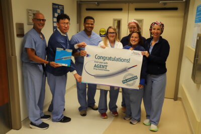 Dr. Muhammad Shuaib, third from left, Jennifer Whitcomb, RN, center in white lab coat, and members of the Roberta G. Veloz Cardiac Cath Lab team. Courtesy photo.