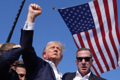 Republican presidential candidate former President Donald Trump reacts as he is surrounded by U.S. Secret Service agents at a campaign rally, Saturday, July 13, 2024, in Butler, Pa. (AP Photo/Evan Vucci)
