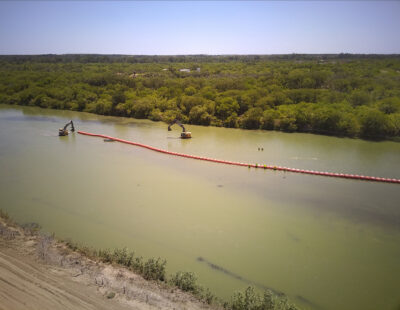 Construction of a floating barrier in the Rio Grande near Eagle