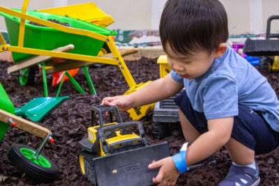 Lukas Kim plays with a toy truck at the LEAP Children's Museum pop-up event Friday morning on July 26, 2024. Trisha Anas/ The Signal.