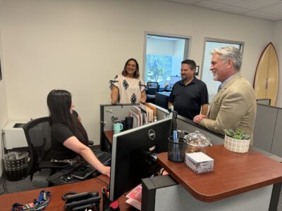 COC Acting Chancellor David Andrus (right) speaks with (from left) administrative assistant Samantha Smith, Assistant Superintendent Jasmine Ruys and administrative assistant James McLaughlin. Tyler Wainfeld/The Signal.