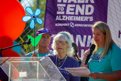 Michelle, a resident at Oakmont of Santa Clarita, holds up a blue flower pinwheel on Saturday morning during the Alzheimer's Association's Walk to End Alzheimer's event at Bridgeport Park. The blue flower signifies that she is living with Alzheimer's. Trisha Anas/ The Signal.