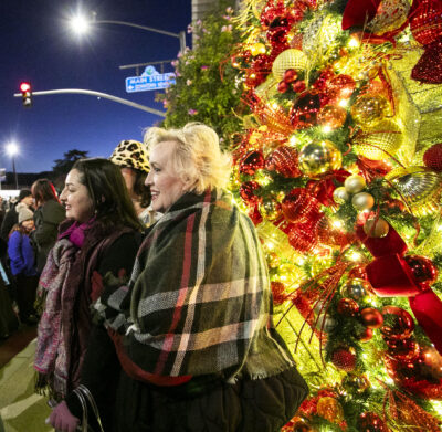 Residents enjoy the newly lit tree, which marks the beginning of the holiday season in Santa Clarita, during Light Up Main Street in Old Town Newhall on Saturday, Nov. 16, 2024. Habeba Mostafa/ The Signal