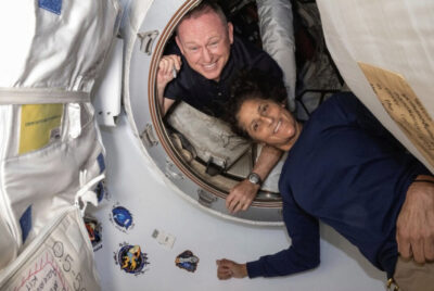 Boeing Crew Flight Test Astronauts Butch Wilmore (L) and Suni Williams pose for a portrait inside the vestibule between the forward port on the International Space Station's Harmony module and Boeing's Starliner spacecraft on June 13, 2024. Photo: NASA.