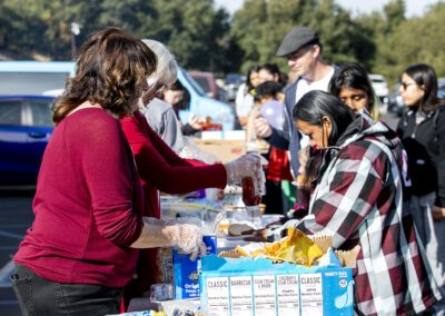 Volunteers from Faith Community Church give out food to attendees during the "Festividad for Christ" event at on Saturday, Dec. 21, 2024. Habeba Mostafa/ The Signal