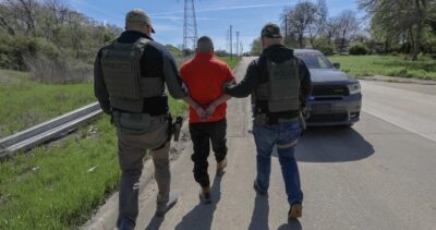 In this file photo, U.S. Immigration and Customs Enforcement officers take into custody one of 216 suspected illegal aliens arrested on March 28, 2024. Photo courtesy of ICE