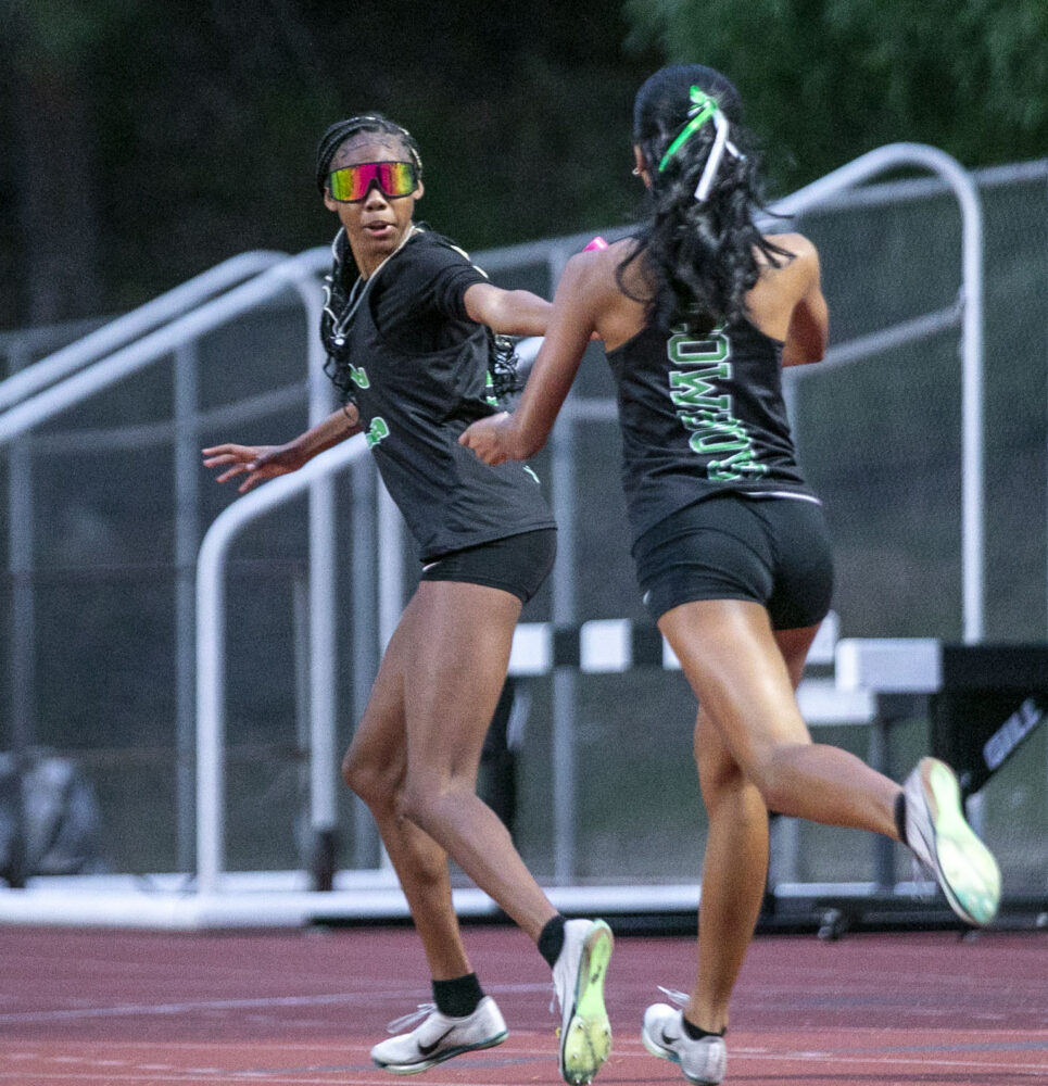 Canyon's Keziah Webster passes the baton to Alaya Graves-Hogains during the varsity girls' 4x400 meter relay at the Foothill League Track and Field Team Championships at College of the Canyons on Thursday, April 17, 2025. Habeba Mostafa/ The Signal