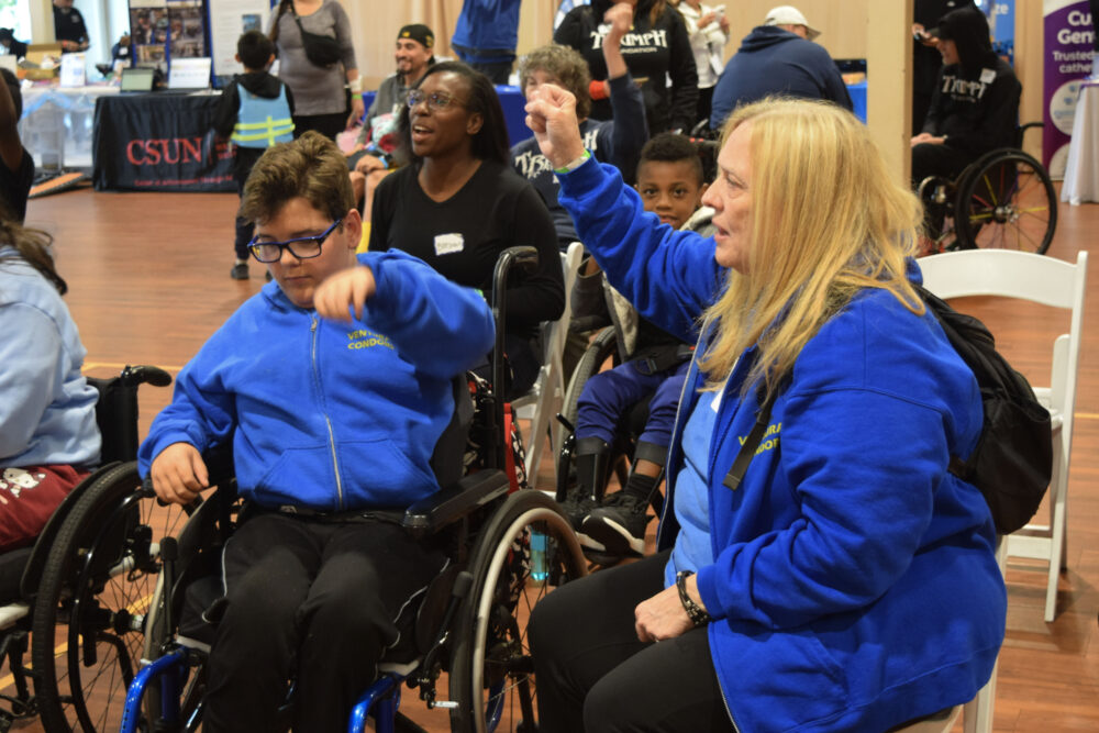 From left: Shawn Wahl, 12, and Robin Beard dance together at the Triumph Foundation's 12th annual Wheelchair Sports event at the George A. Caravalho Santa Clarita Sports Complex Gymnasium, April 26, 2025. Kamryn Martell/The Signal