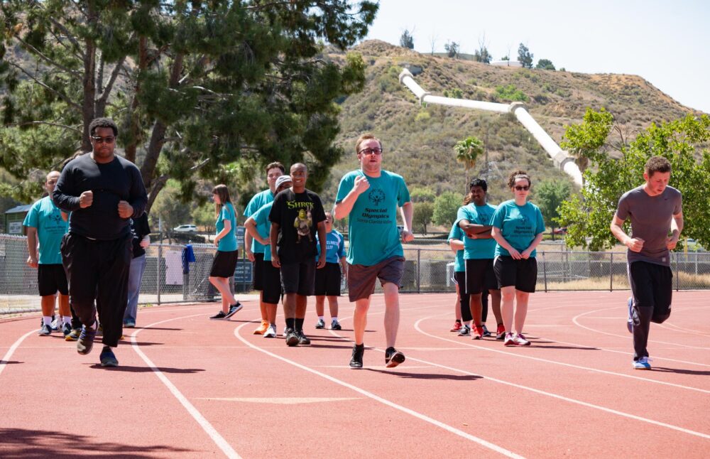 Special Olympics athletes from the Santa Clarita Valley warm up with a light jog during their morning practice at Saugus High on May 31, 2025 in preparation for their competition in Long Beach. Katherine Quezada/The Signal