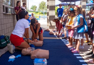 Lifeguards Kalista Imo (front left) and Danae Plascencia present a CPR demonstration to attendees of the Water Safety Day event on June 21, 2025 at the Santa Clarita Aquatic Center in Santa Clarita, Calif. Katherine Quezada/The Signal