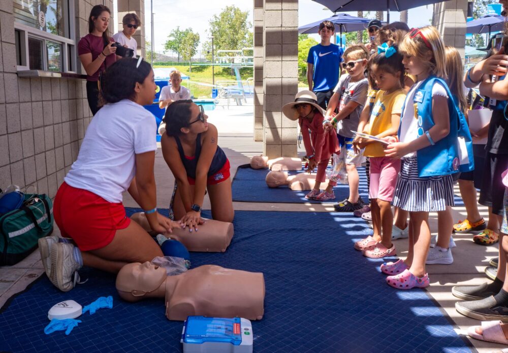 Lifeguards Kalista Imo (front left) and Danae Plascencia present a CPR demonstration to attendees of the Water Safety Day event on June 21, 2025 at the Santa Clarita Aquatic Center in Santa Clarita, Calif. Katherine Quezada/The Signal