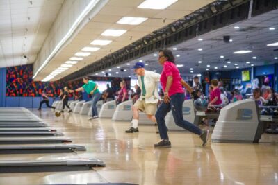 Guests bowl at the annual STRIKE OUT Breast Cancer tournament aimed to raise funds for the Susan G. Komen 2025 Walk to End Breast Cancer scheduled for later this year, on July 12, 2025 at the Santa Clarita Lanes in Saugus, Calif. Katherine Quezada/The Signal