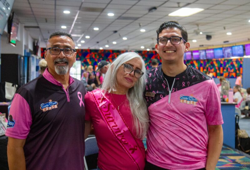 From left: Anthony Guevara, Christine Guevara, and their son Anthony Guevara Jr. at the annual STRIKE OUT Breast Cancer tournament at the Santa Clarita Lanes aimed to raise funds for the Susan G. Komen 2025 Walk to End Breast Cancer scheduled for later this year, on July 12, 2025 in Saugus, Calif. Katherine Quezada/The Signal