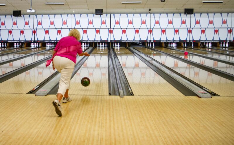 Cancer survivor Mimi Baum rolls the bowling ball down the lane during the annual STRIKE OUT Breast Cancer tournament at the Santa Clarita Lanes aimed to raise funds for the Susan G. Komen 2025 Walk to End Breast Cancer scheduled for later this year, on July 12, 2025 in Saugus, Calif. Katherine Quezada/The Signal