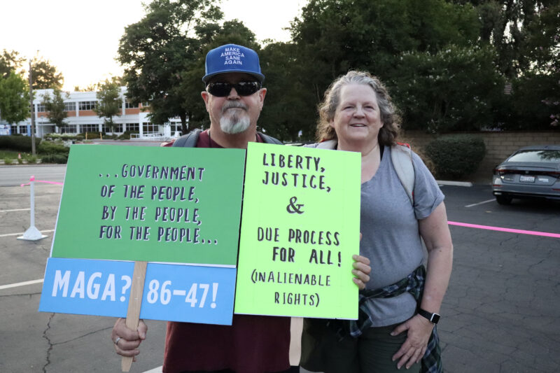 Jeff Chaffin (L) and Chris Davis-Chaffin (R) hold their signs to show support at the Good Trouble Interfaith Vigil at the Valencia United Methodist Church in Valencia, Thursday, July 17, 2025. Kamryn Martell/The Signal