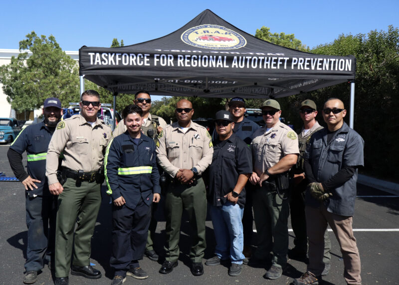Santa Clarita Valley Sheriff's Station deputies pose with Taskforce for Regional Auto-Theft Prevention workers and Freeway Towing tow truck workers at the SCV Sheriff’s Station Catalytic Converter Etching Event in Valencia, Saturday, July 19, 2025. Kamryn Martell/The Signal