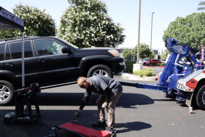 Frank Shin, a Taskforce for Regional Auto-Theft Prevention detective, prepares to work on an attendee's car at the Santa Clarita Valley Sheriff’s Station Catalytic Converter Etching Event in Valencia, Saturday, July 19, 2025. Kamryn Martell/The Signal