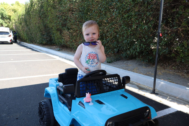 Weston Flanagan, one-and-a-half, poses in his little car at the Santa Clarita Valley Sheriff’s Station Catalytic Converter Etching Event in Valencia, Saturday, July 19, 2025. Kamryn Martell/The Signal
