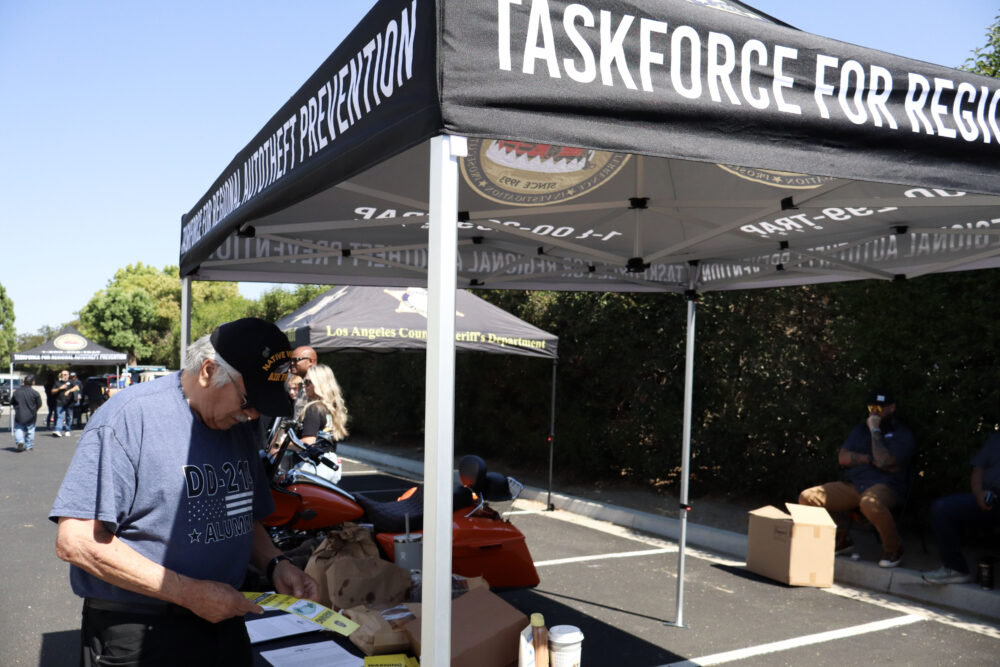 Rodney Luna looks at some pamphlets at the Santa Clarita Valley Sheriff’s Station Catalytic Converter Etching Event in Valencia, Saturday, July 19, 2025. Kamryn Martell/The Signal