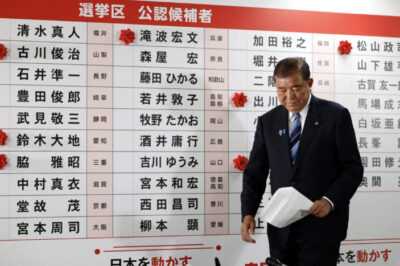 Japanese Prime Minister and president of the ruling Liberal Democratic Party (LDP), Shigeru Ishiba, walks in front of a board with red paper roses showing elected candidates in Tokyo, Japan on July 20, 2025. Franck Robichon/Pool via Reuters