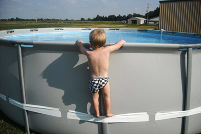 A child uses the compression strap to climb up the pool, illustrating the hazard involved. Photo: Consumer Product Safety Commission