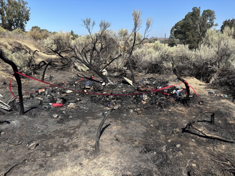 A spot that was part of a half-acre fire was where a body was found Tuesday night, the area charred and taped off in the Santa Clara River wash in Canyon Country, July 23, 2025. Michael Picarella/The Signal