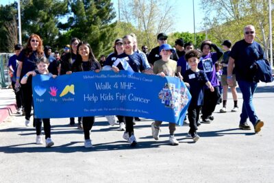 File art: Millie Jones (between the four kids holding the banner) leads hundreds of participants at the annual Walk 4 MHF at Central Park in Saugus, April 5, 2025. Michael Picarella/The Signal