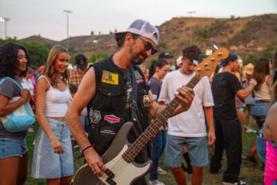 Redneck Rodeo singer Toddy C. Bass joins the crowd as they line dance during the "Concerts in the Park" on Aug. 2, 2025 in Saugus, Calif. Katherine Quezada/The Signal