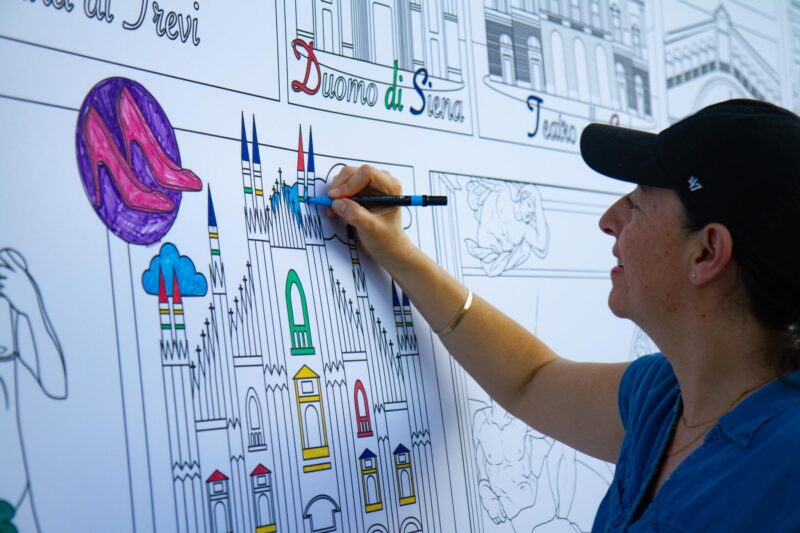 Castaic resident Miriam Chavez colors in part of a large mural of Italy’s most famous locations during the Celebrate culture series on Aug. 8, 2025, an event hosted by the city of Santa Clarita at the Canyon Country Community Center in Canyon Country, Calif. Katherine Quezada/The Signal
