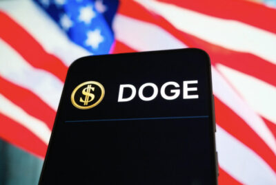 The Department of Government Efficiency (DOGE) website is displayed on a phone. Photo illustration by Oleksii Pydsosonnii.