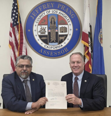Los Angeles County Auditor-Controller Oscar Valdez (left) and Assessor Jeff Prang finalize the official transfer of the 2025 Assessment Roll, which reflected more than $2 trillion in net value. Photo Courtesy of the Los Angeles County Assessor's Office.
