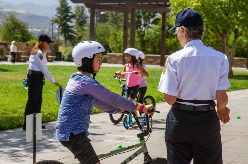 Volunteers with the California Highway Patrol instruct children on bicycle safety during the Youth and Family Festival hosted by Assemblywoman Pilar Schiavo’s office, D-Chatsworth in partnership with Strength United, a CSUN community agency on Aug. 16, 2025 at the Canyon Country Community Center, in Canyon Country, Calif. Katherine Quezada/The Signal