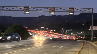 A car hauler transporting several Teslas caught fire while traveling southbound on Interstate 5 just north of Balboa Boulevard on Saturday evening, shutting down all lanes of the freeway. Signal staff photo.