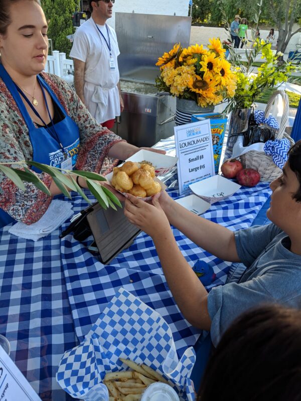 Fresh loukoumathes, donut treats drizzled with honey, nuts and cinnamon, are among the many popular and authentic Greek treats served at the annual Pasadena Greek Food Festival. Photo Pasadena Greek Food Festival.