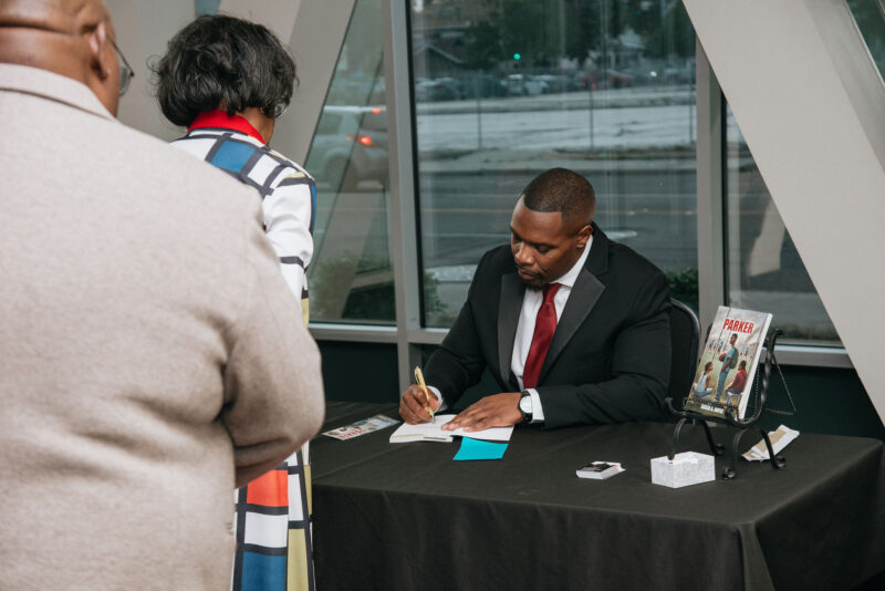 Saugus High School graduate David Doyle signs copies of his novel, "Parker," at a recent signing event. Courtesy photo.