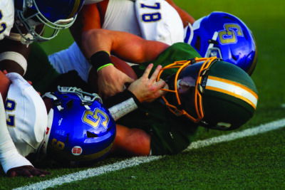 Canyon quarterback Carson Soria (8) is tackled by Charter Oak players during the first half of Friday’s game, Aug. 22, 2025 at Canyon High. Katherine Quezada/The Signal