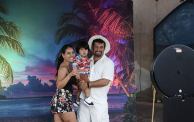 Evelyn Palagashvili (L), Andre Palagashvili (C), 2, and Simon Palagashvili take a family photo at the photo booth at the "Caribbean Nights"-themed Senses Block Party on Main Street in Newhall, Thursday, Aug. 22, 2025. Kamryn Martell/The Signal