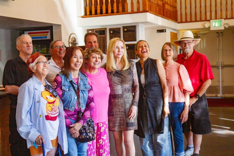 Santa Clarita Artists Association member Nadia Lusian (center wearing brown dress) celebrates her art exhibit with her collegues at the Canyon Theatre Guild on Aug. 9, 2025 in Old Town Newhall, Calif. Katherine Quezada/The Signal