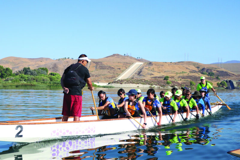 Emmy Montilla (standing left) is calling the paddling rhythm for team. He has been a coach with Team Dragon Eyes since 2018 and started paddling in 1995 in the Philippines.